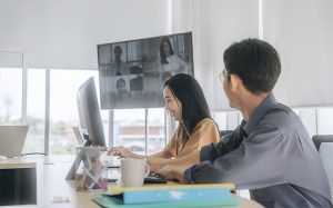 Colleagues in a bright office engaging in a video call